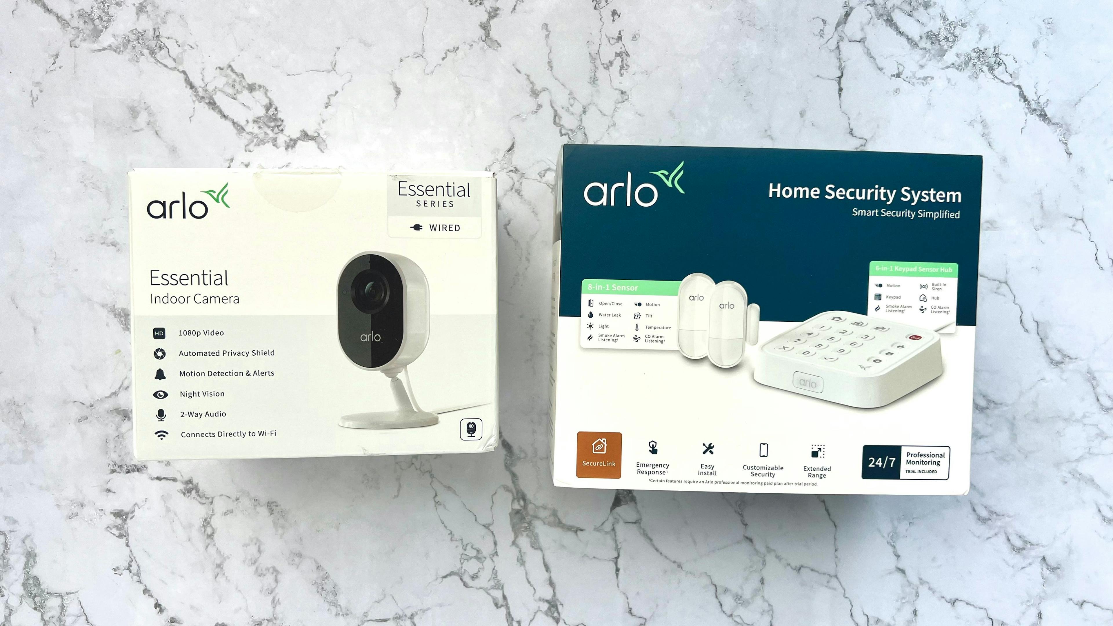 Arlo home security system and indoor camera on table